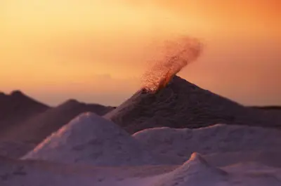An ice volcano erupts surrounded by other hills