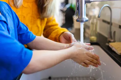 Boy washing his hands in the sink