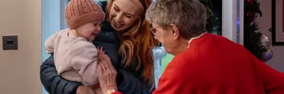 Mother and daughter visiting an elderly family member