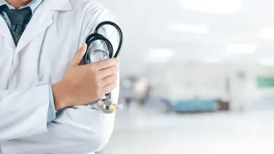 Close up of a doctor holding a stethoscope in an office.