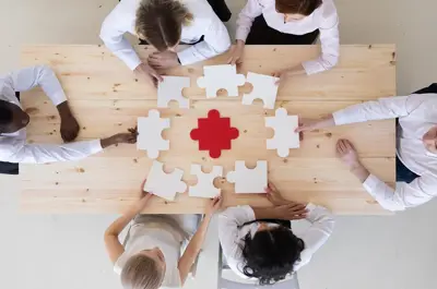 A team of business people assembling a puzzle with the center being a health sign.