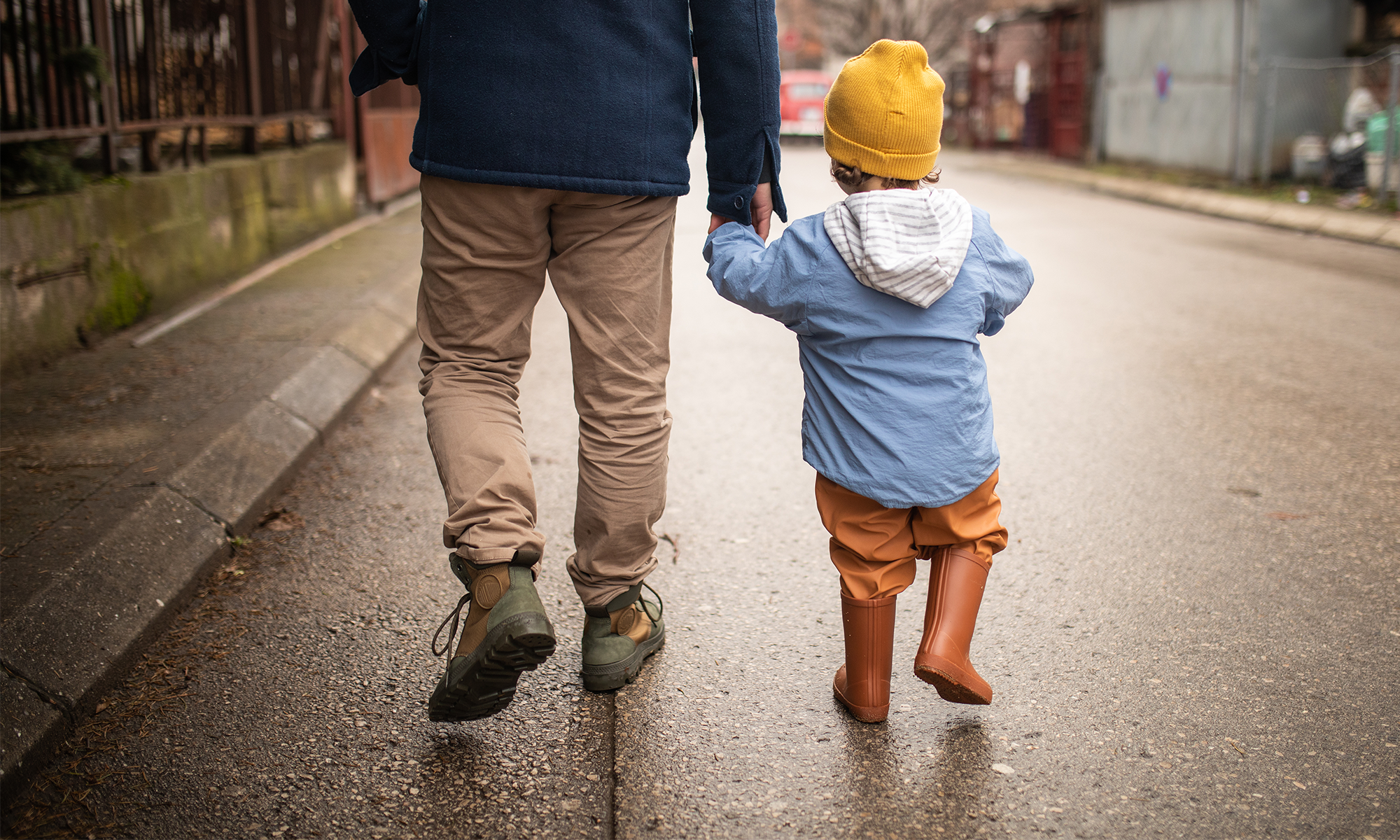 father and son walking on street